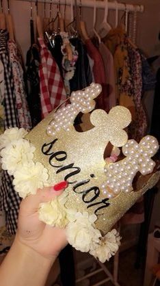 a person holding up a gold mickey mouse mask with flowers in front of her face