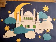 paper cut out of the shape of a mosque with clouds and stars around it on a blue background