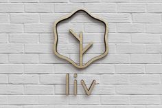 a white brick wall with a wooden sign that says viv and the word live on it