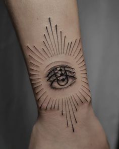 an eye with rays coming out of it on the side of a woman's leg