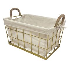 a white and gold basket with handles on the bottom is holding a baby's diaper