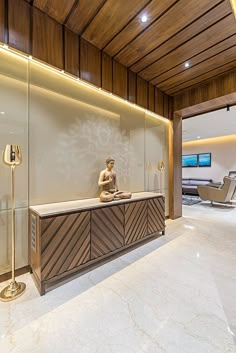 a statue sitting on top of a counter in a living room next to a glass wall