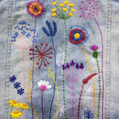 an embroidered jean jacket with flowers on it