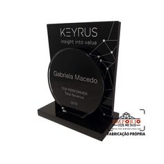 a black plaque with the words keyrus inside it and an image of a clock on top