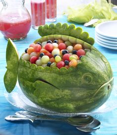 a watermelon shaped like a fish with fruit in it