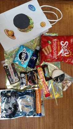 an assortment of snacks and candy on a table