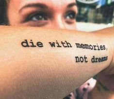 a person with a tattoo on their arm that says die with memories, not dreams