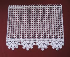 a white doily on a red surface