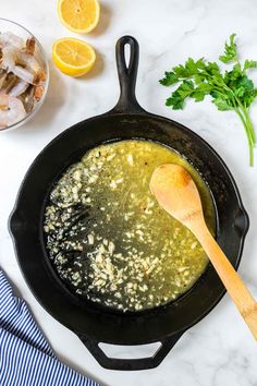 a skillet filled with broth and some other ingredients