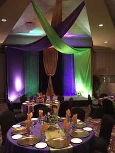 a banquet room with purple and green decor