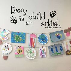 there is a sign that says every child is an artist and paper plates are hanging on the wall