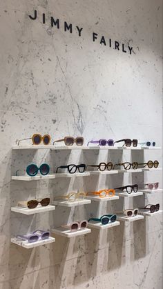 the jimmy farly eyewear collection is on display in front of a marble wall