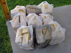 many bags of wood are sitting on the sidewalk