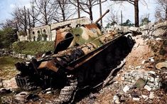 an old tank sitting on top of a pile of rubble