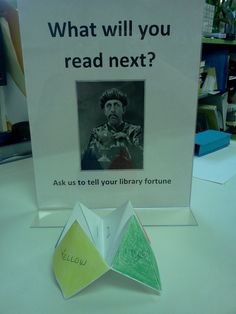 an origami folded book with the caption what will you read next? ask us to tell your library fortune