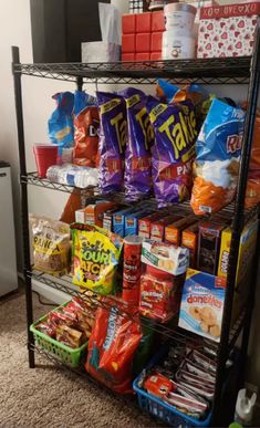 a metal shelf filled with lots of food and snacks on top of it's sides