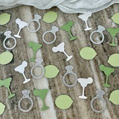 green and white paper cutouts with silver glitter rings