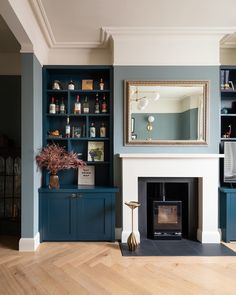 a living room filled with furniture and a fire place in front of a tv mounted on a wall