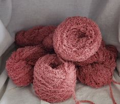 several pink crocheted yarns piled on top of each other