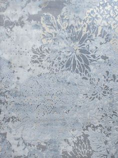 an area rug with flowers on it in blue and grey colors, including white dots