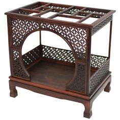 an intricately carved wooden stand with two trays on each side and one section open