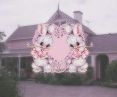 a pink heart shaped frame with two white rabbits on it in front of a house