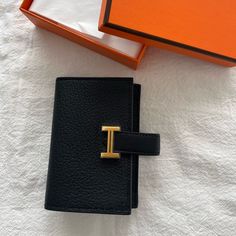 Authentic Hermes Mini Wallet In Mysore Goatskin -Noir/Black Color With Gold Hardware -B Stamp - Leather Tab With "H" Closure - Change Purse With Snap Closure - 2 Credit Card Slots ** Very Hard To Get Color And Leather Made In France Metallic Finish: Gold Plated Dimensions: L 10.8 X H 7.5 X D 0.4 Cm Hermes Wallet Women, Luxury Black Wallets For Daily Use, Designer Black Wallets With Leather Lining, Luxury Black Wallets With Gold-tone Hardware, Black Business Wallet With Gold-tone Hardware, Business Black Wallet With Gold-tone Hardware, Designer Black Wallet With Gold-tone Hardware, Timeless Black Wallets For Travel, Designer Black Wallets With Gold-tone Hardware