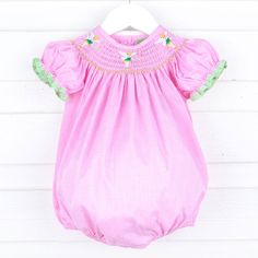 Experience enchanting moments with our Neverland Fairy Smocked Bubble. A perfect choice for playdates, birthdays, or your next magical theme park visit. This pink gingham bubble features our favorite green fairy smocked across the neckline. Adorable bishop sleeves with green gingham tape trim add a whimsical touch to this charming dress, ensuring it's perfect for your little one's memorable adventures. Features snaps in stride for easy dressing and diaper changes. Magical Theme, Cousin Gifts, Kids Dress Wear, Green Fairy, Green Gingham, Street Kids, Infant Girl, Christmas Pjs, Girl's Back