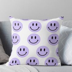 a purple pillow with smiley faces on it