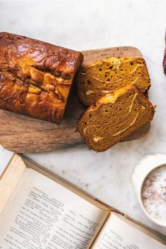 sliced loaf of pumpkin bread next to an open book