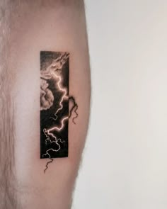 a man's arm with a lightning tattoo on it