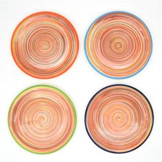 four plates with different designs on them are arranged in the shape of spirals and circles