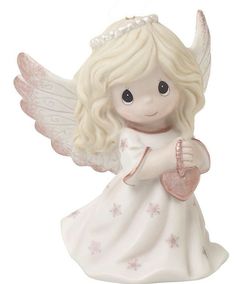 a white angel figurine with wings and a heart in her hand, on a white background