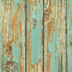 an old wooden wall with peeling paint on it