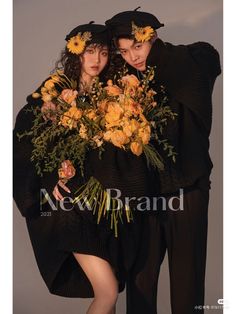 two people are dressed in black with flowers on their heads and one person is holding his arm around the other