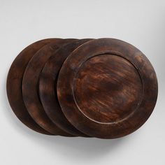 four wooden plates stacked on top of each other