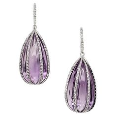 Adorned with two mesmerizing pink amethyst drops totaling an impressive 80.21 carats. Each pink amethyst is delicately framed by sparkling diamond strips, featuring a total of 258 round diamonds weighing 1.47 carats. They are crafted in 18k white gold weighing 7.62 grams. Pink amethyst is thought to aid in emotional healing and peace because of its calming energy and spiritual importance. These drop earrings will subtly enhance your appearance and make you stand out with their bright beauty, whe Luxury Briolette Amethyst Earrings, Luxury Amethyst Dangle Earrings, Luxury Purple Earrings With Gemstone Accents, Luxury Amethyst Drop Earrings, Amethyst And Diamond Earrings, Stone Jewellery, White Gold Set, Sparkling Diamond, Amethyst Jewelry