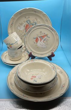 an assortment of porcelain dishes and cups on display