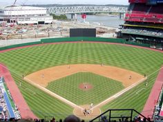 an aerial view of a baseball field with people on the field and in the stands