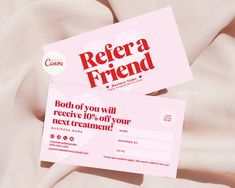 two pink business cards with the words refer a friend on them