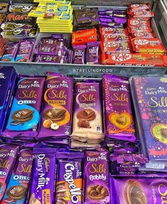 a display case filled with lots of different types of chocolates and candy bar wrappers