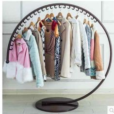 an iron rack with clothes hanging on it