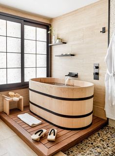 a bathroom with a large wooden tub next to a pair of high heeled shoes