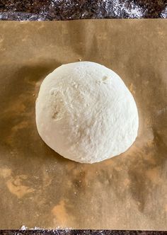 a ball of dough sitting on top of a piece of wax paper