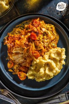 a blue plate topped with mashed potatoes and meat