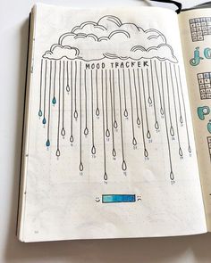 an open notebook with rain drawn on it