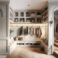 a large walk in closet with wooden flooring and white cupboards filled with coats