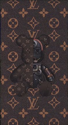 a teddy bear is sitting in the middle of a louis vuitton wallpaper