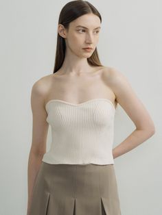 Editor's NotesThis is a knit bustier top in which the knitted fabric of the bust line and the front line are knitted in a three-dimensional sense. It is a coordinating item that looks fashionable when worn over a shirt or ribbon T-shirt.- Slim fit makes the waist look slim- Unique styling items for fall and winter- Available in 3 colors: Ivory, Blue, Gray*The color of the product may differ from the actual color depending on the device and resolution used.Measurements(in.)ONE SIZE (XS-M)- Length (Based on chest line): 11.02 in.- Length (Based on back center): 9.06 in.- Chest: 11.22 in.- Waist: 11.02 in.- Hem: 11.02 in.- Bust line rib height: 0.39 in.*Model size: Height 5'74, Bust 32.5, Waist 25, Hips 37*The size of the product may have an error of 0.39 to 1.18 inch depending on the measure Chic Bandeau Top With Built-in Bra, Fitted Knitted Beige Tops, Fitted Beige Knitted Tops, Fitted Cropped Fine Knit Tops, Fitted Fine Knit Cropped Top, Fitted Fine Knit Cropped Crop Top, Fitted Beige Tops With Built-in Bra, Fine Knit Fitted Cropped Top, Fine Knit Fitted Cropped Crop Top