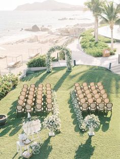 an outdoor ceremony setup with chairs and flowers